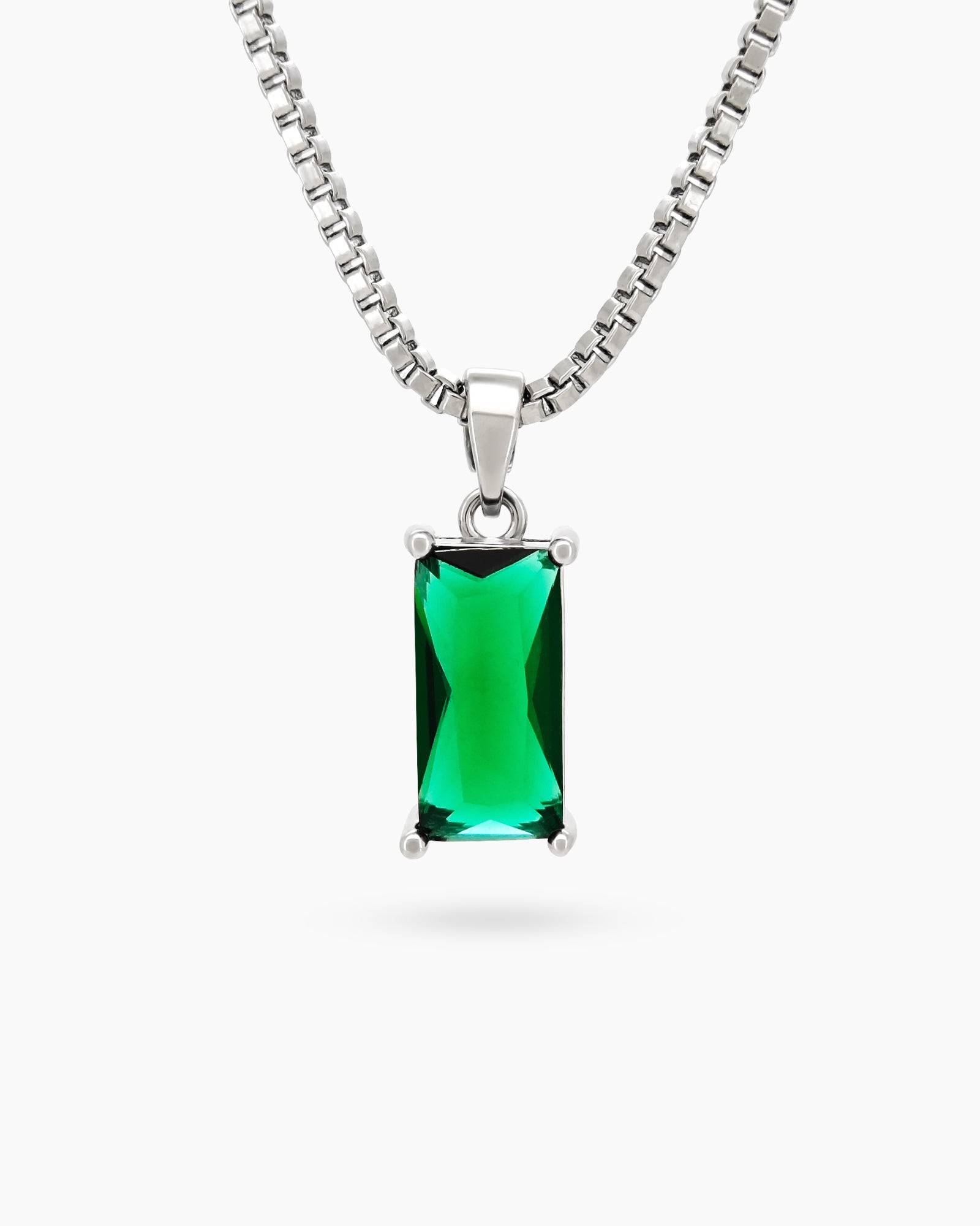 A necklace with a bright green stone on a sleek, light-catching silver chain for a spellbinding look
