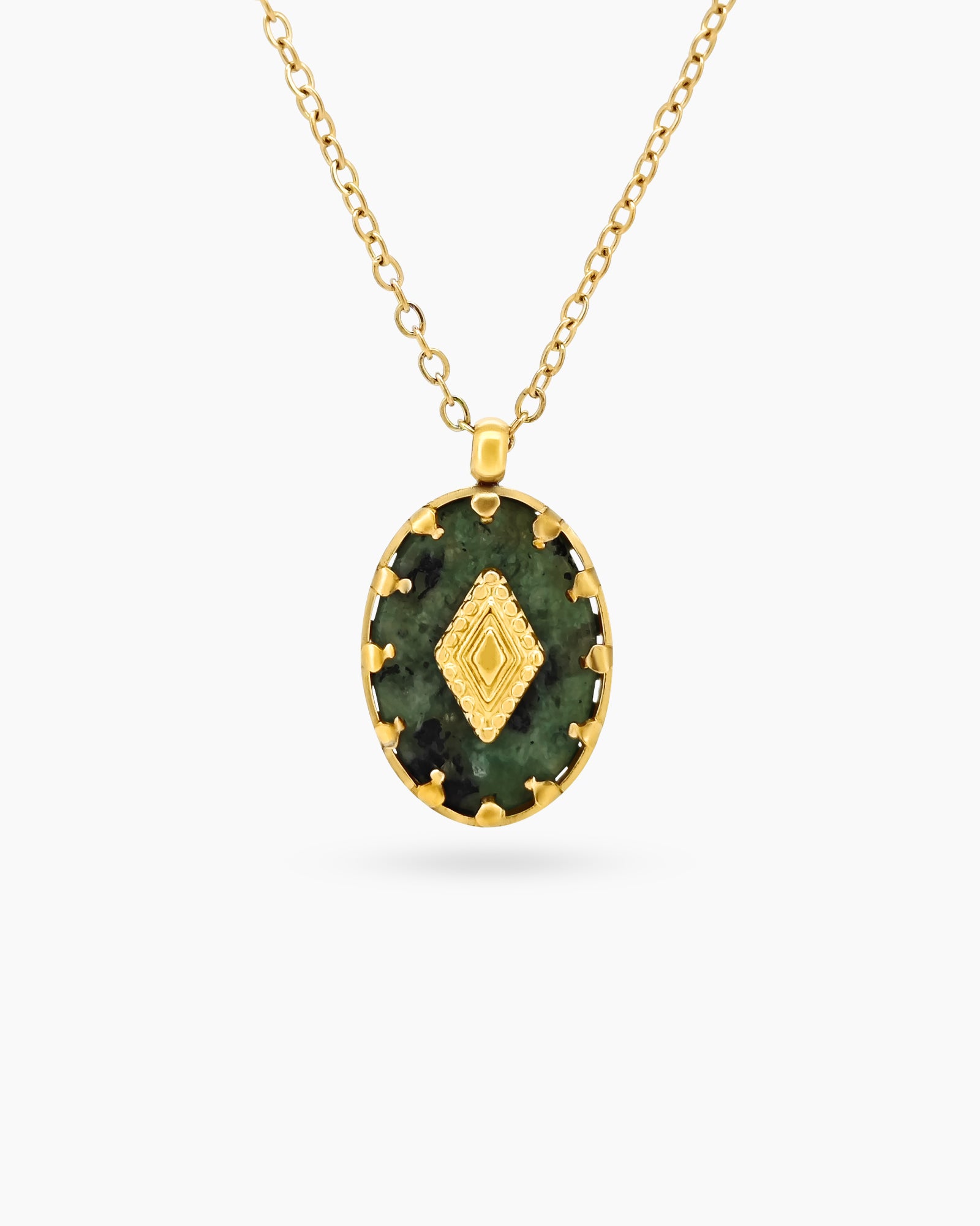 A necklace with a green african pine stone pendant in a textured gold-toned bezel with a diamond motif
