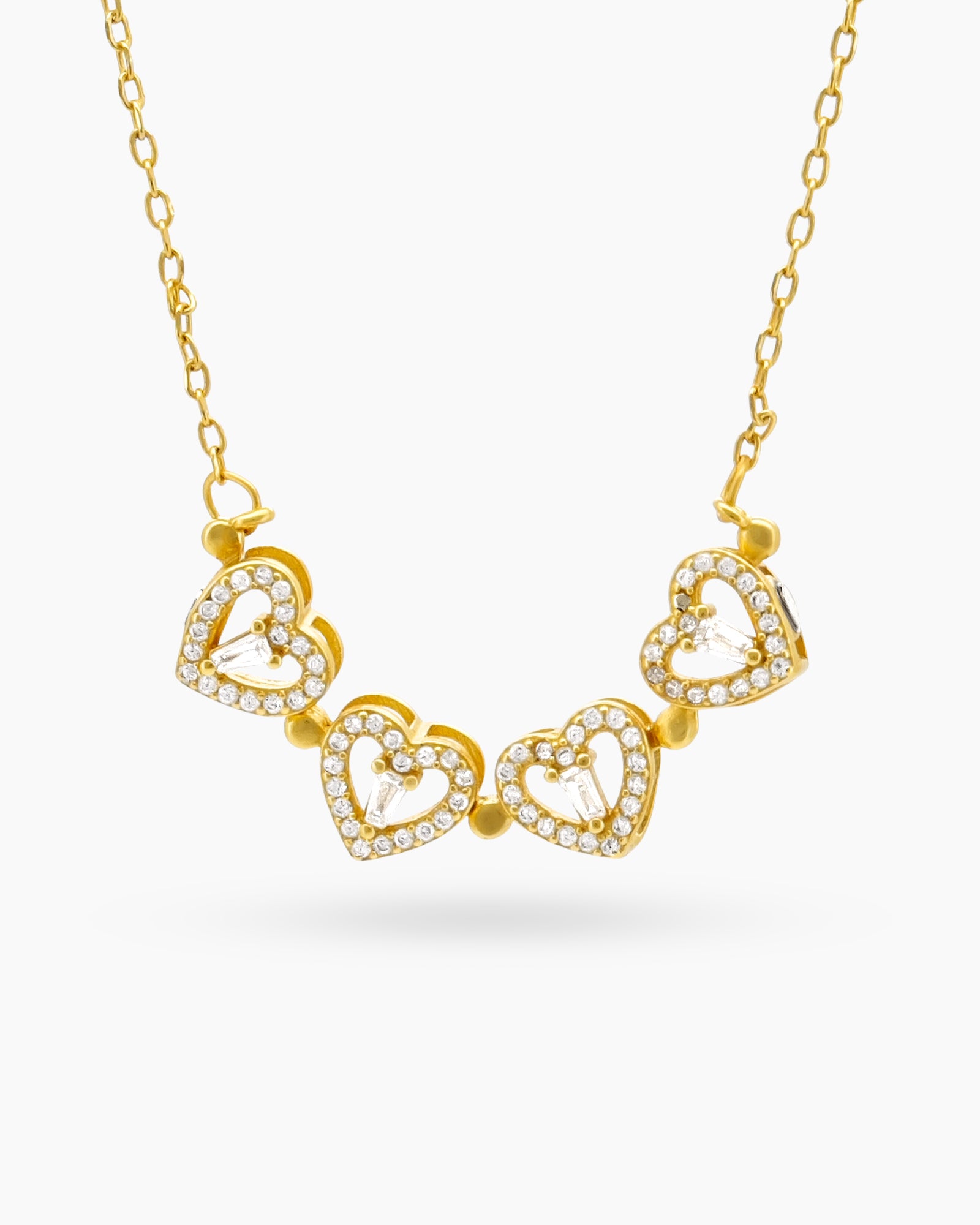 A gold necklace with a clover-inspired pendant of four pavé-outlined hearts that opens up