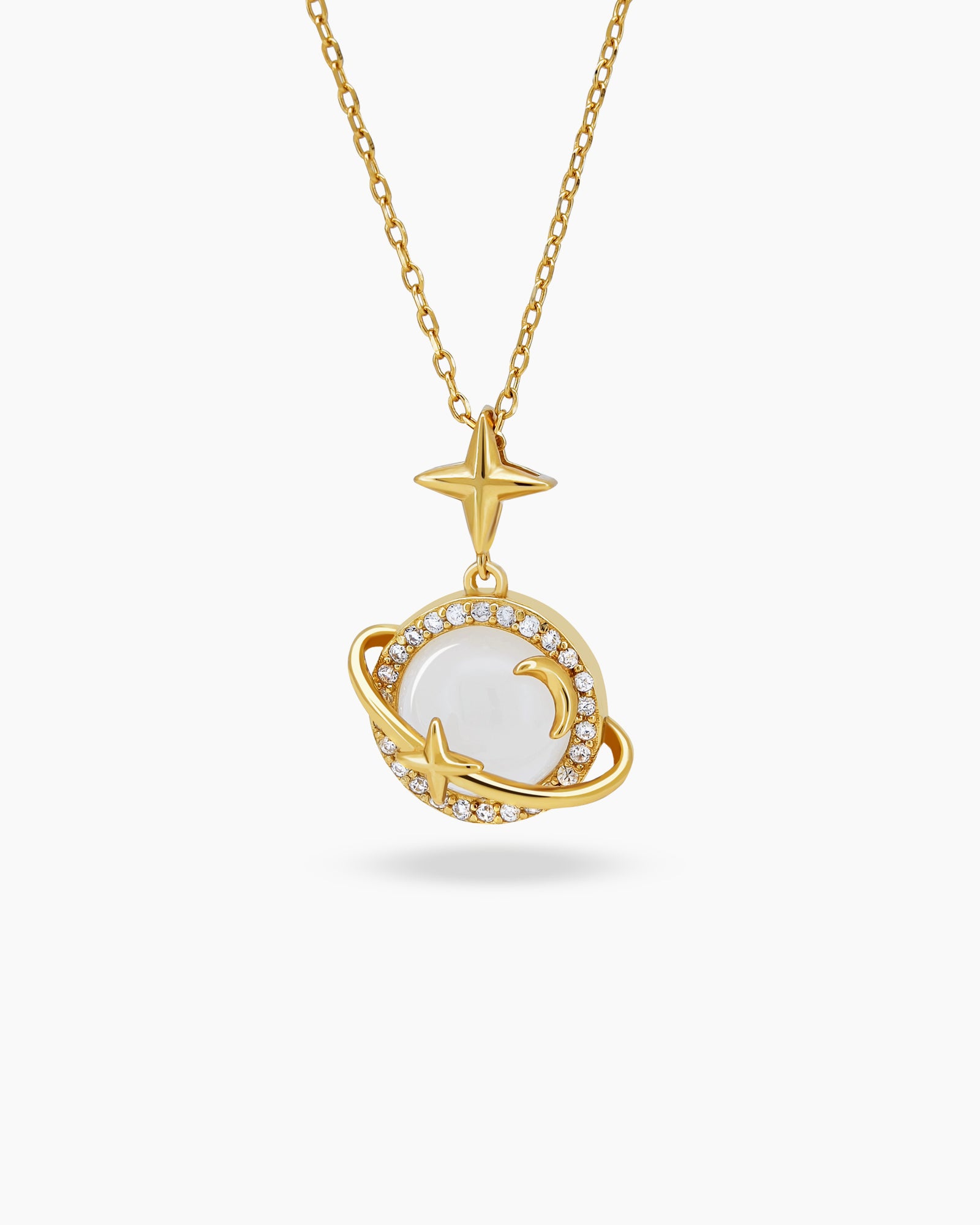 A necklace with a delicate round pendant, haloed with pavé stones, and a soft moon-shaped detail inside
