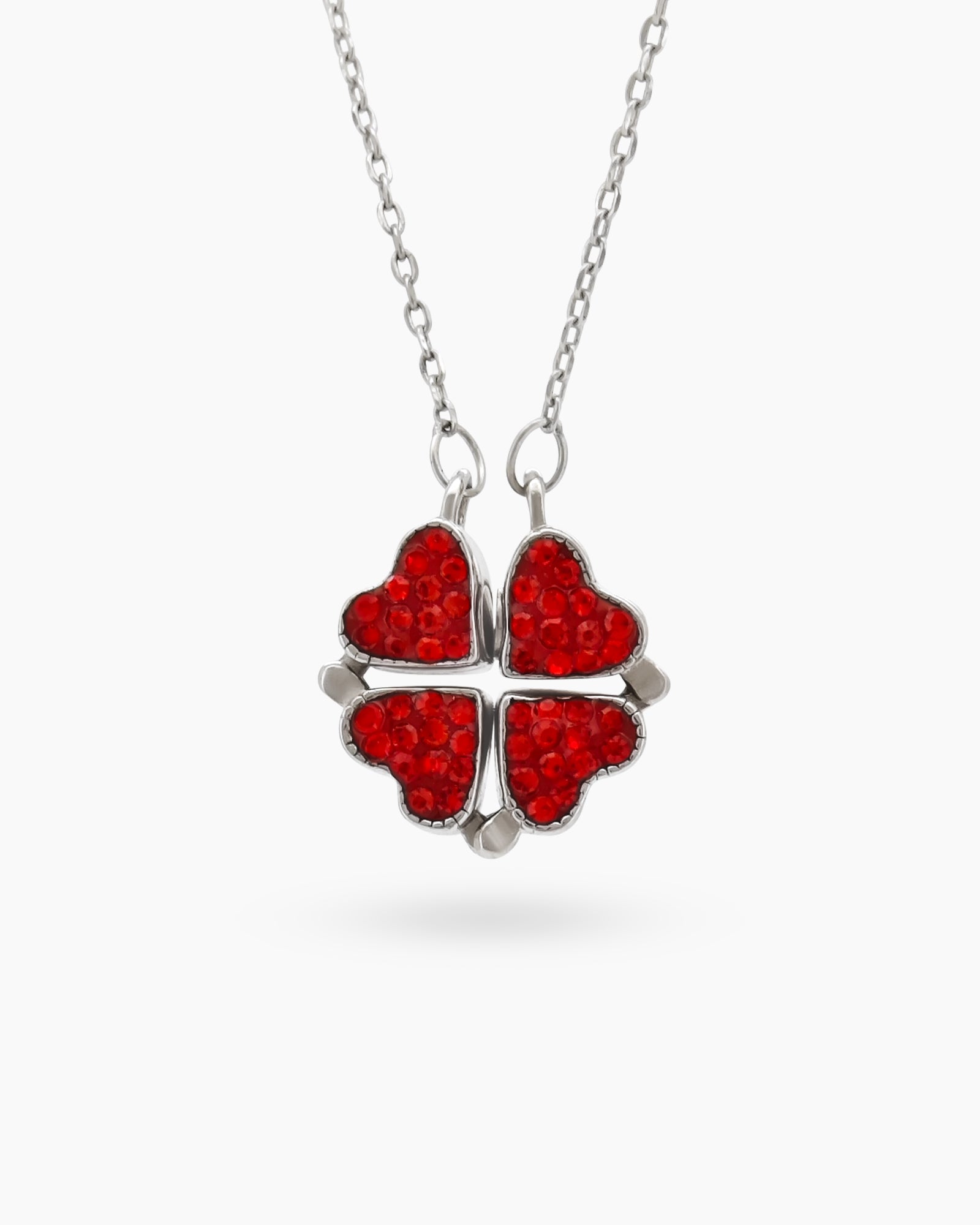 A necklace with a double-faceted finish in vivid ruby red and deep navy on a clover-shaped pendant