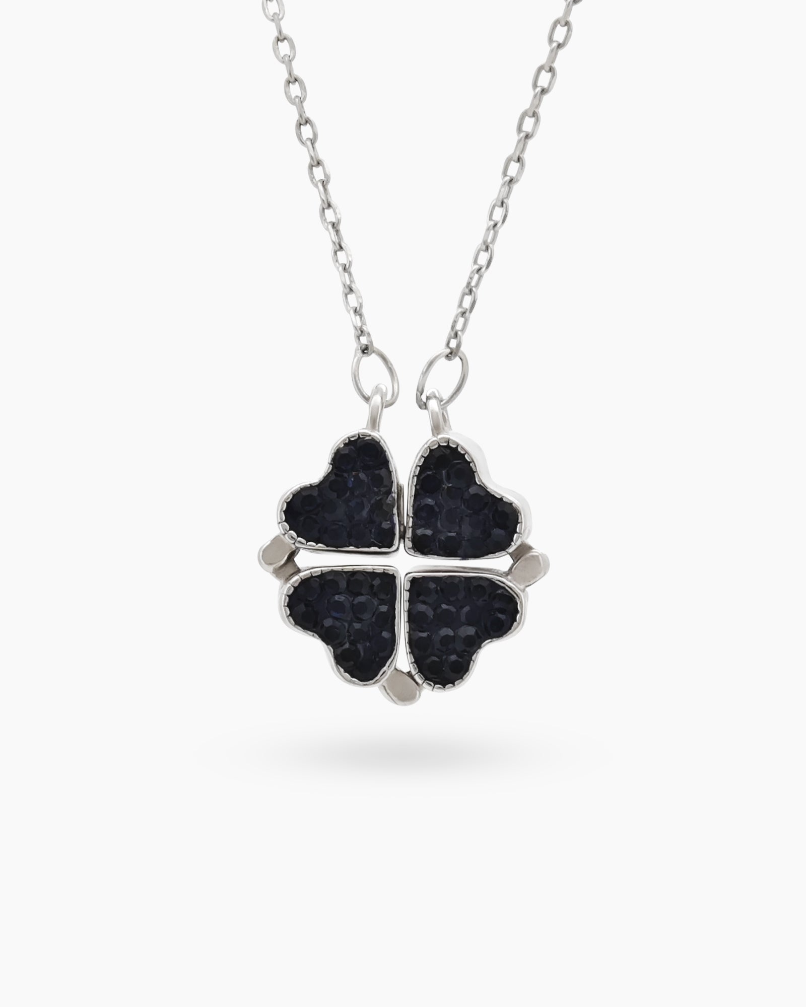 A necklace with a double-faceted finish in vivid ruby red and deep navy on a clover-shaped pendant