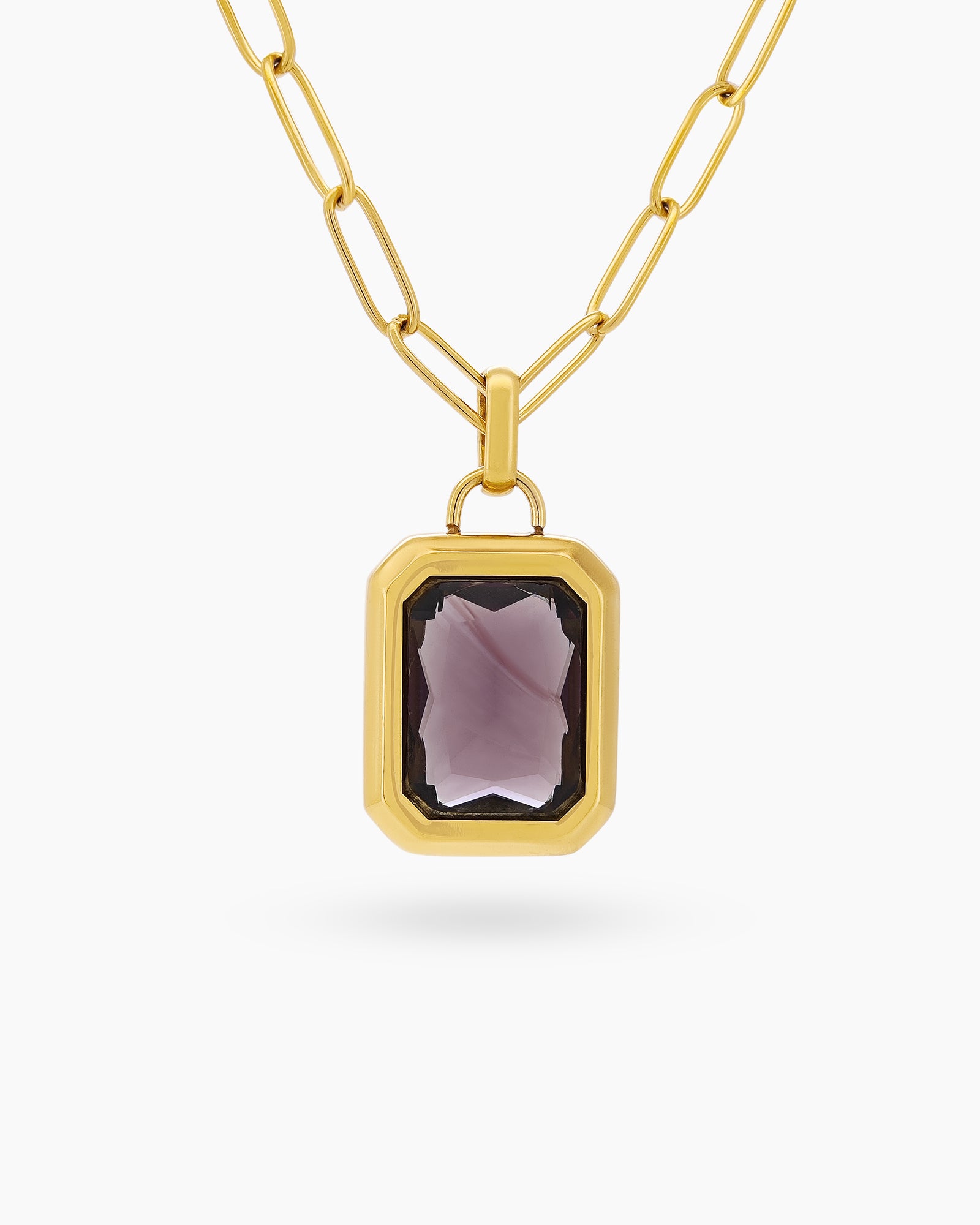 A necklace with a large, emerald-cut green zircon stone in a sleek bezel on a paperclip chain
