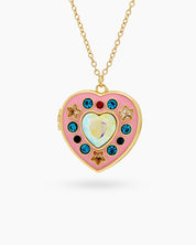 A gold-toned locket with a pink enamel heart, adorned with colorful zircons and golden star details