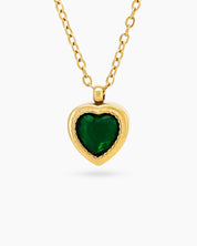 A green necklace with a heart-shaped zircon centerpiece in an antique-inspired gold bezel