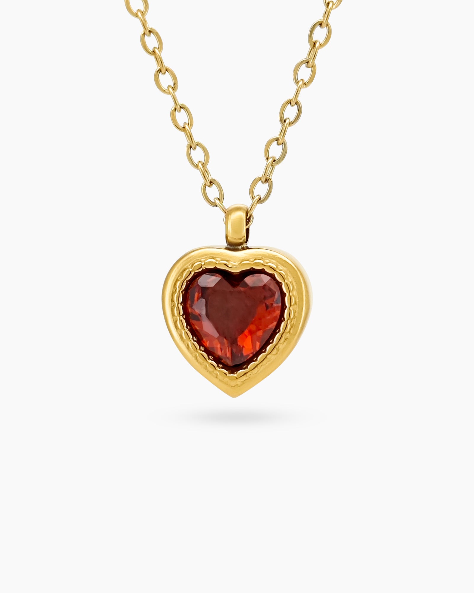 A red necklace with a heart-shaped zircon centerpiece in an antique-inspired gold bezel