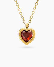 A red necklace with a heart-shaped zircon centerpiece in an antique-inspired gold bezel