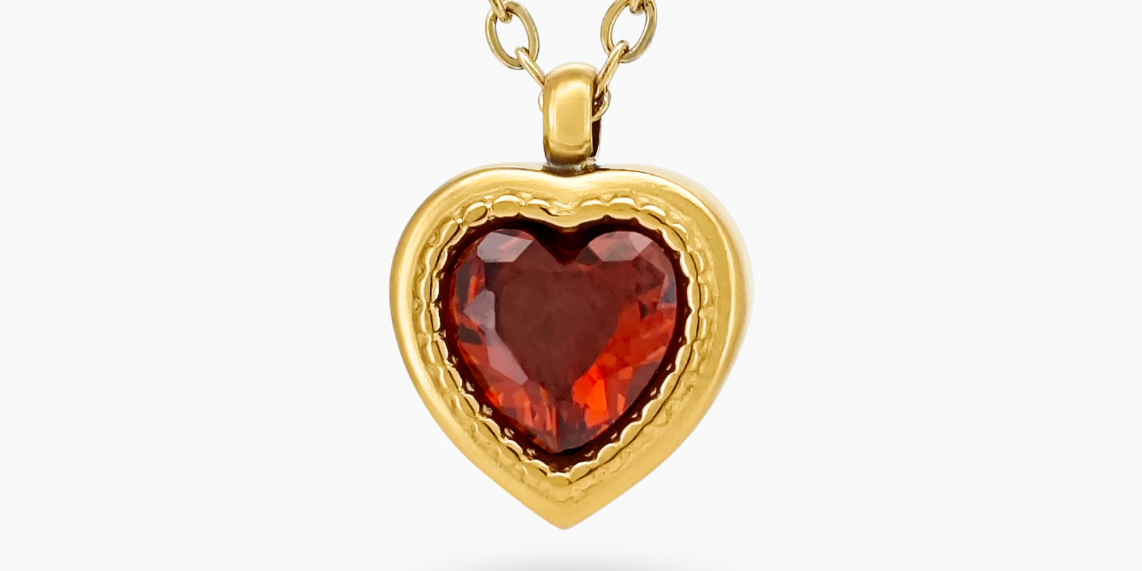 A red necklace with a heart-shaped zircon centerpiece in an antique-inspired gold bezel