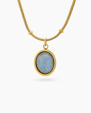 A necklace with an oval-cut cat eye stone on a vintage-inspired satellite chain for a romantic look