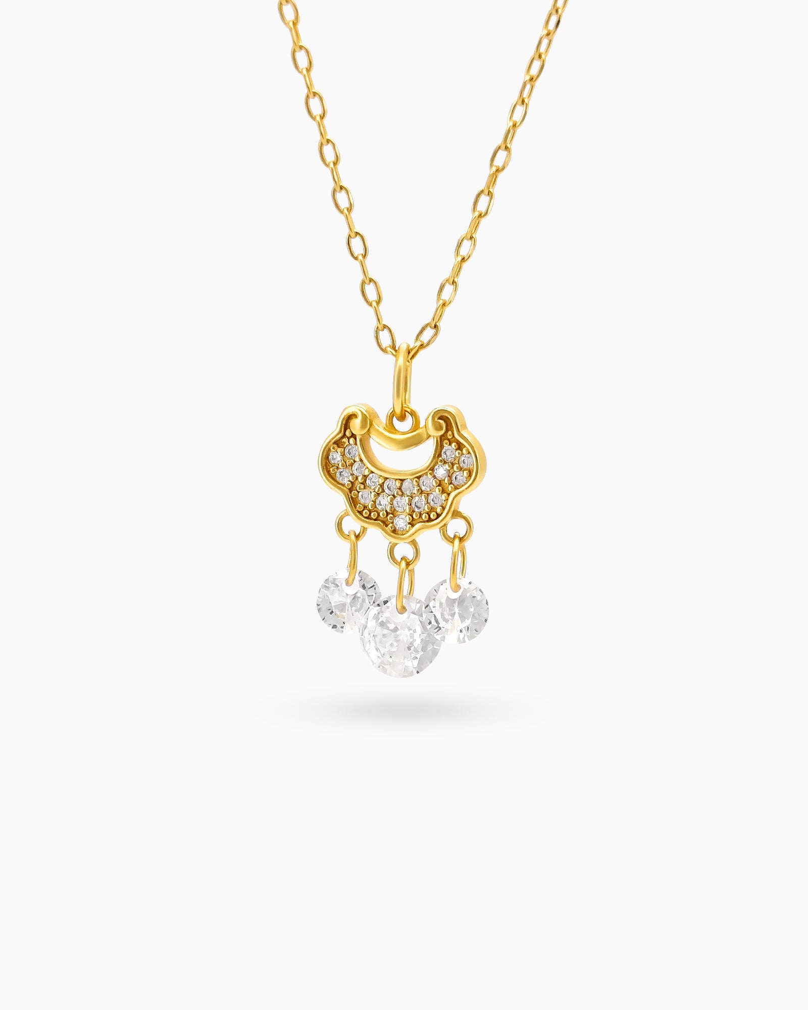 A necklace with an intricately curved gold-tone pendant, paved with delicate crystals and three drop crystals