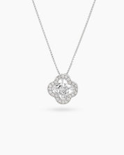 A white necklace with a clover pendant outlined in pavé zircons and a faceted four-petal center stone