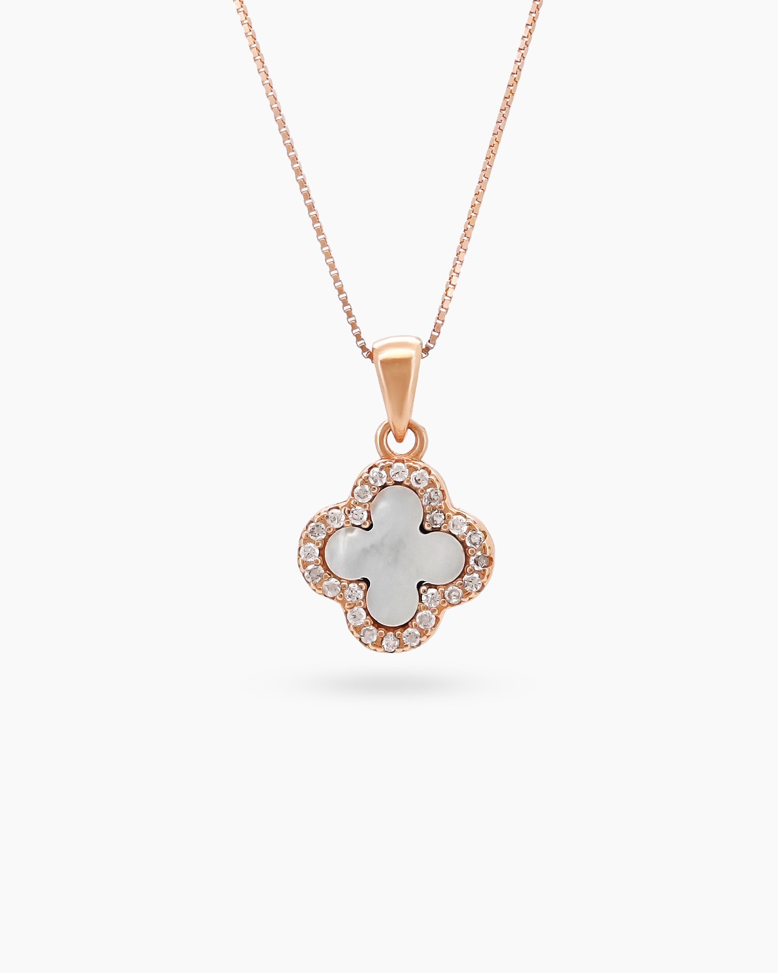 A rose gold necklace with a reversible four-leaf clover pendant, with mother-of-pearl on one side