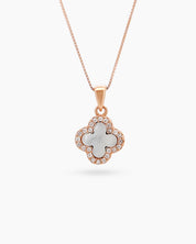 A rose gold necklace with a reversible four-leaf clover pendant, with mother-of-pearl on one side