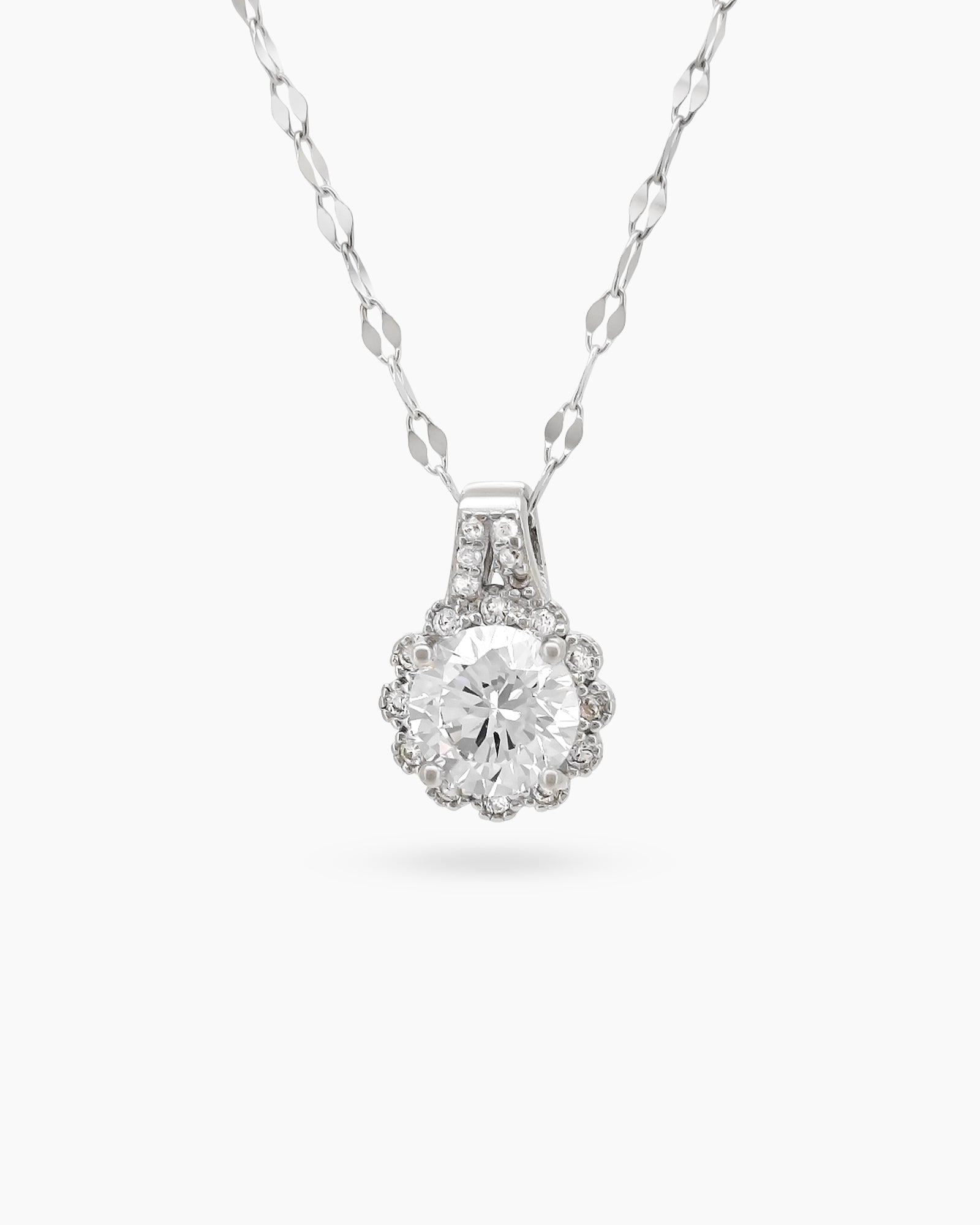 A necklace with a brilliant-cut white zircon pendant, framed by a sparkling halo of micro-set stones
