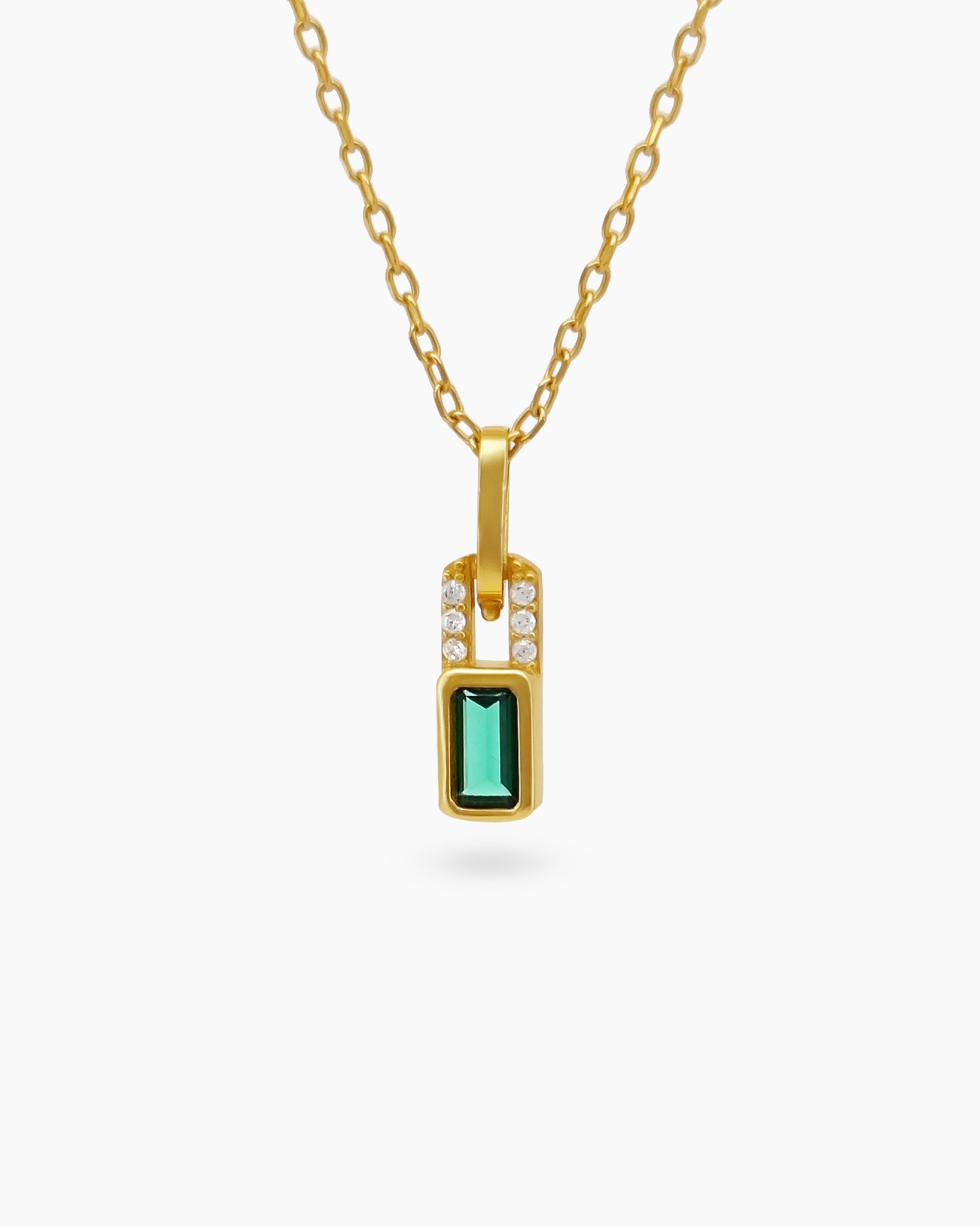 A necklace with a baguette-cut emerald green zircon stone framed by a vertical row of petite white stones