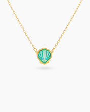 A seafoam necklace with a hand-engraved resin shell pendant in a fine gold-tone bezel on a dainty chain