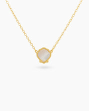 A white necklace with a hand-engraved resin shell pendant in a fine gold-tone bezel on a dainty chain