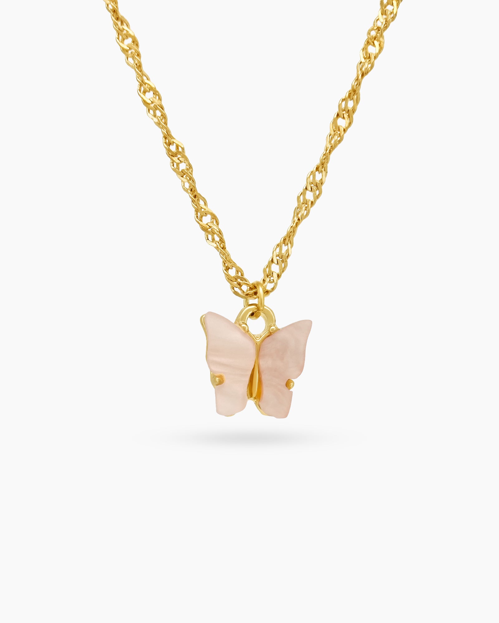 A fine gold-toned chain necklace with a modern butterfly pendant carved from glossy light-pink resin