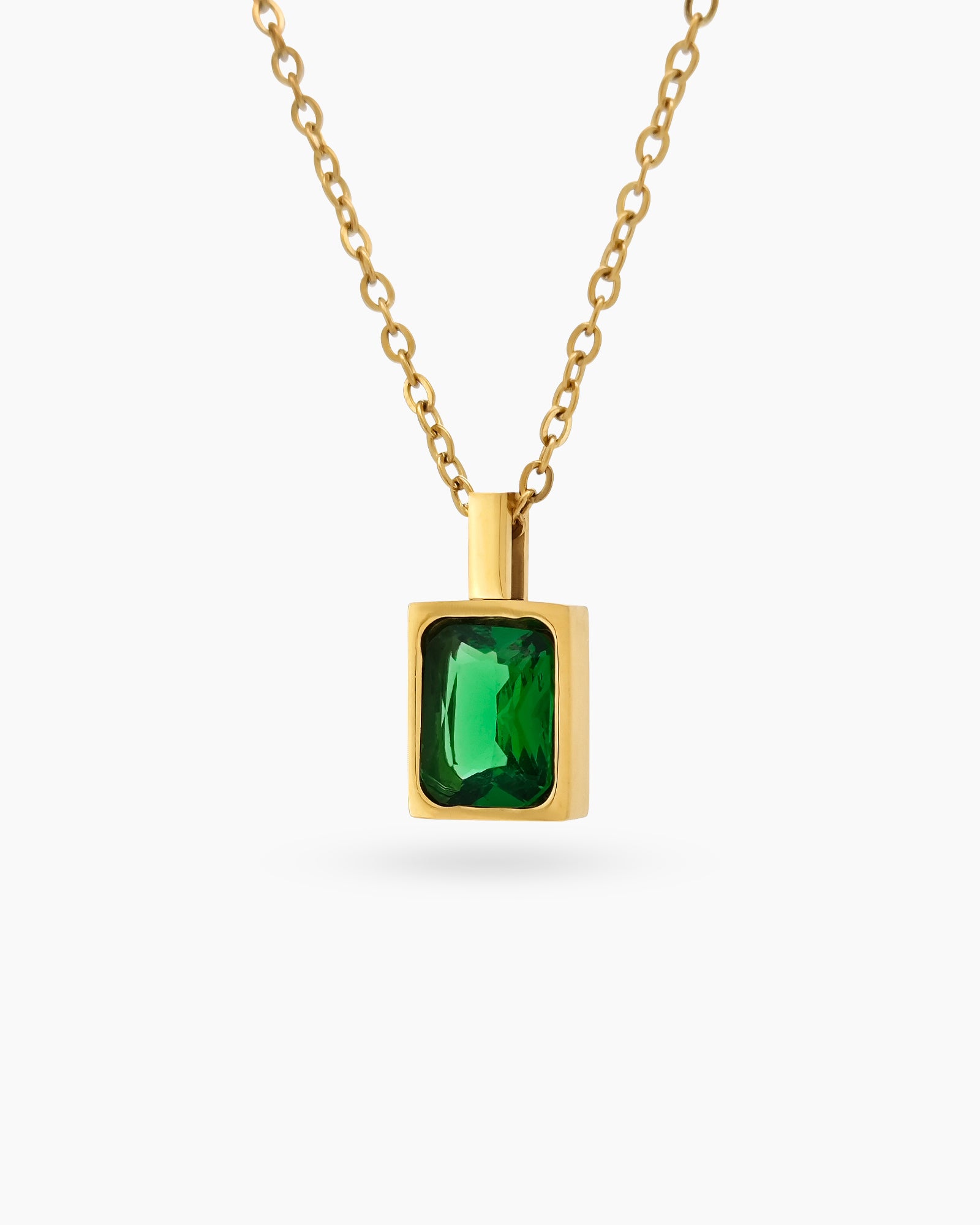 A green necklace with a precisely faceted emerald-cut zircon in a sleek bezel setting on a delicate chain