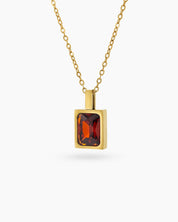 A red necklace with a precisely faceted emerald-cut zircon in a sleek bezel setting on a delicate chain