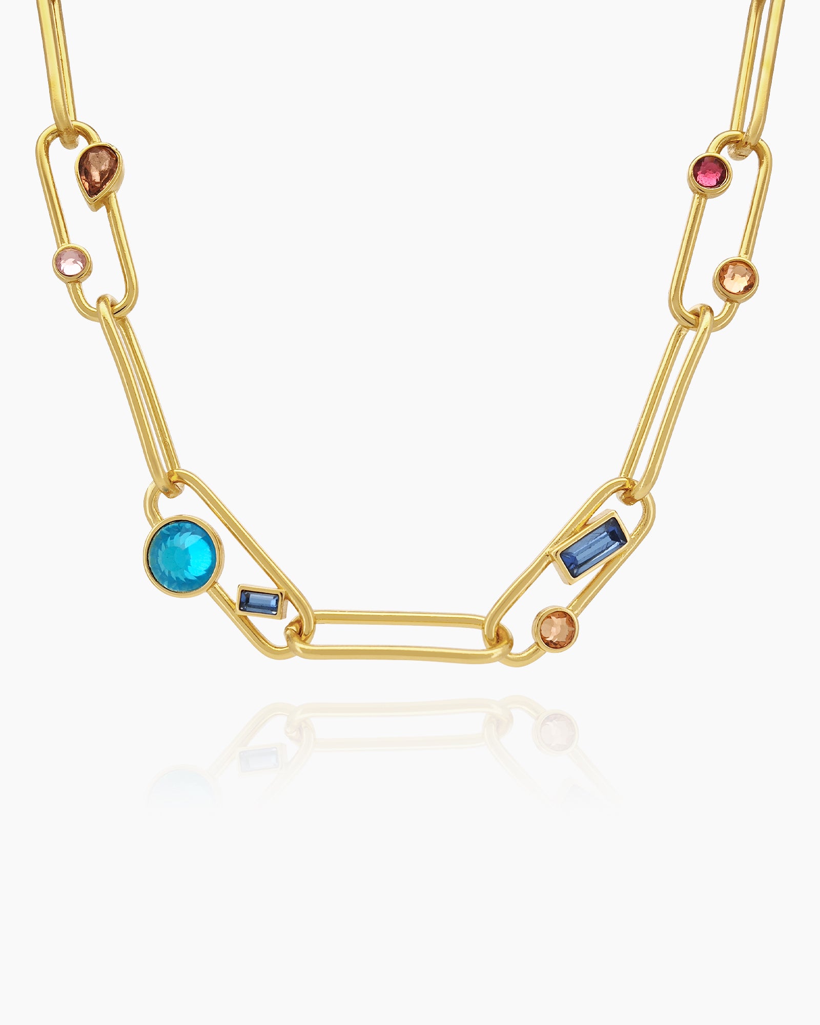 A necklace of oversized gold-tone paperclip links, adorned with an array of multicolored crystal stones