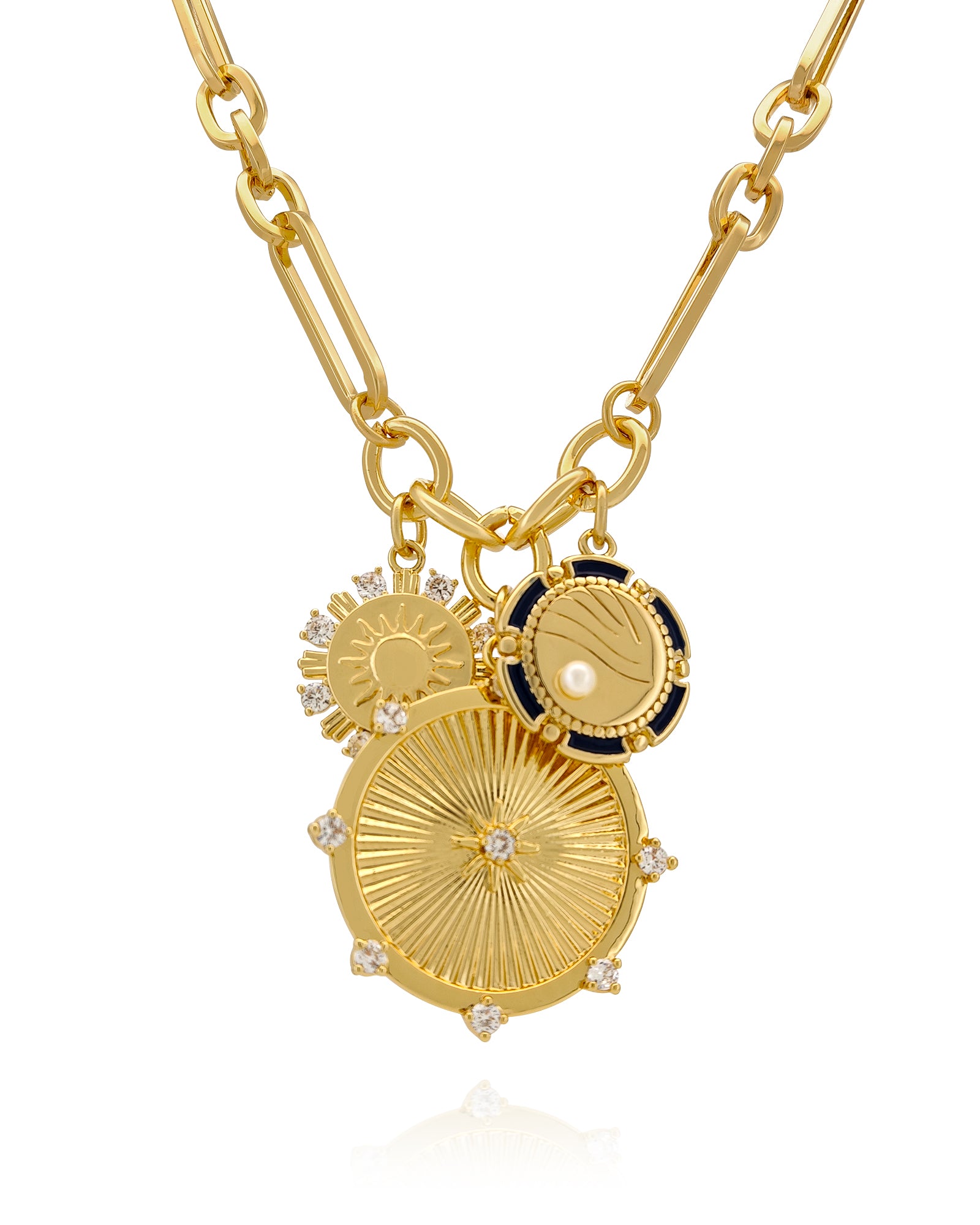 A necklace with a sunburst medallion, a radiant sun charm, and a cosmic disc on an elongated gold chain