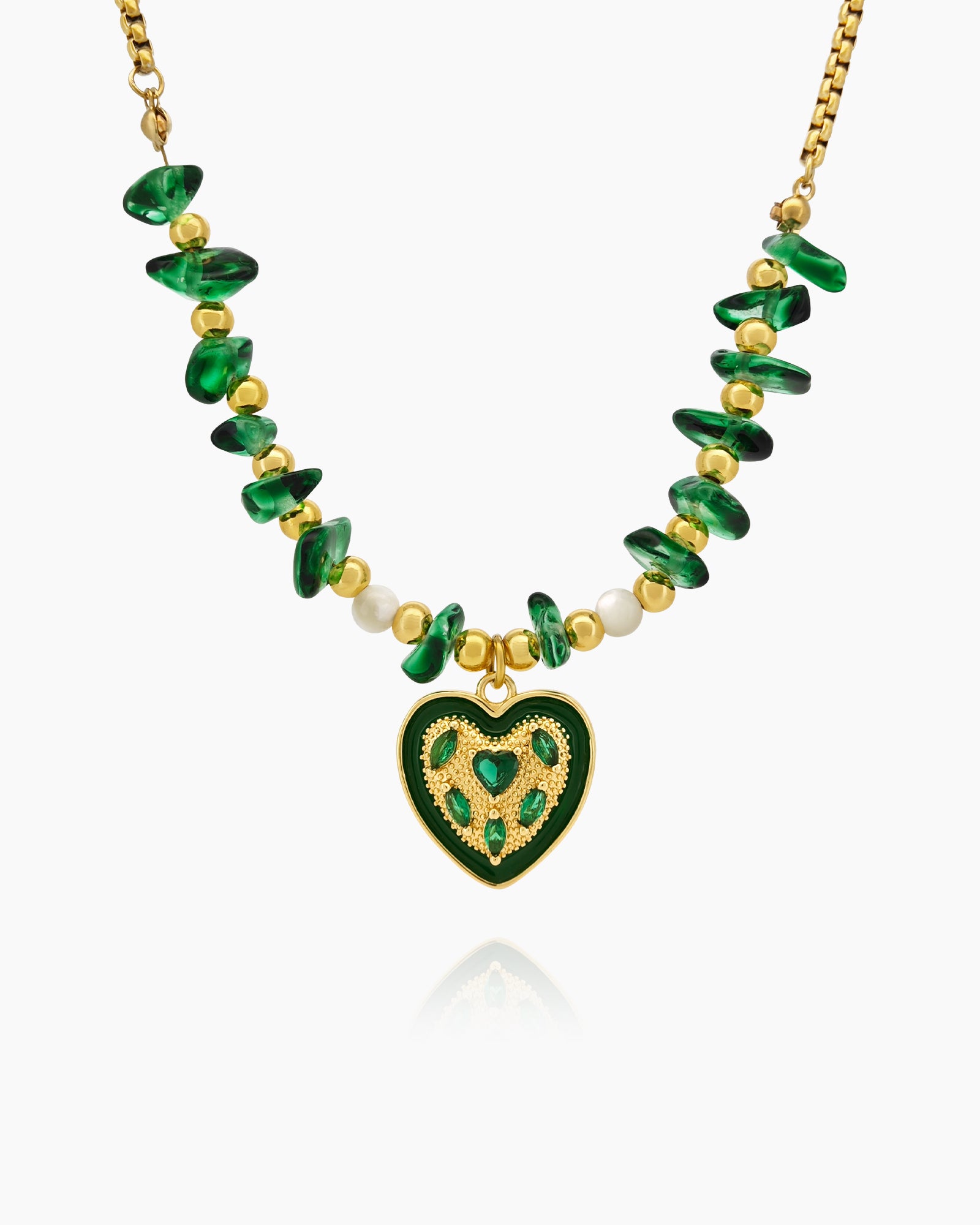 A necklace of rich green malachite chips, soft pearls, and a green enamel heart with golden detailing