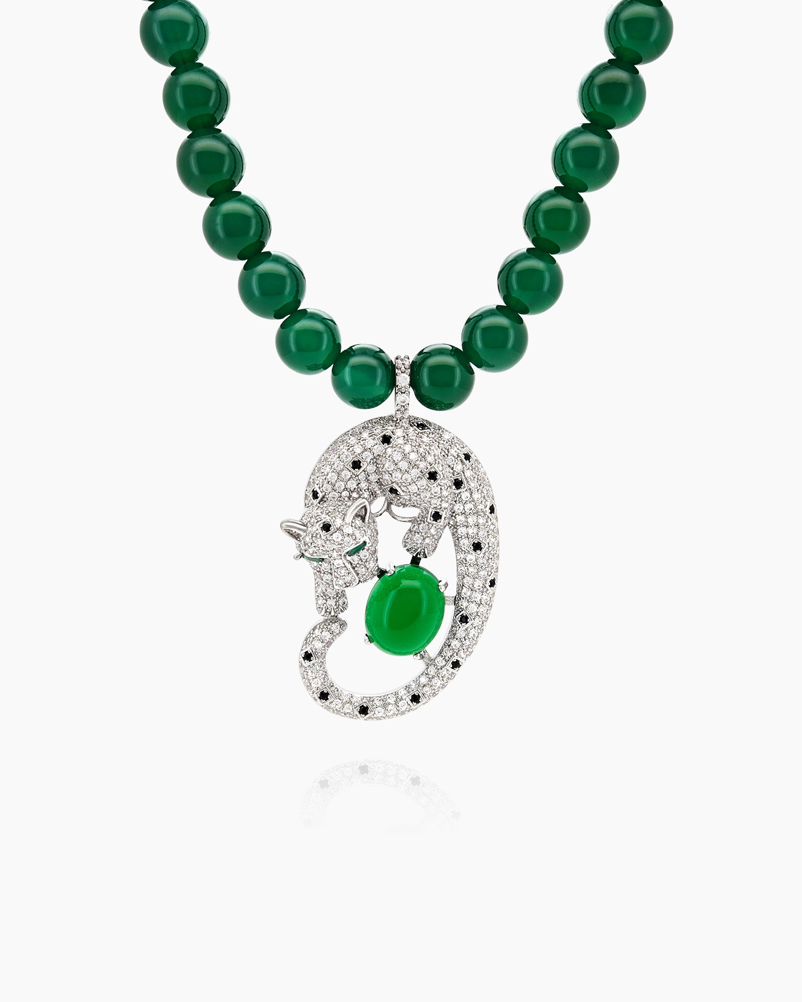 A necklace with a full strand of deep green jade beads and a striking silver-tone panther pendant