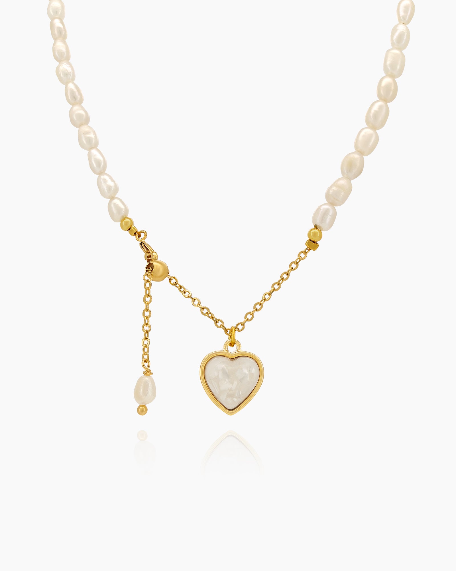A necklace with a graceful strand of freshwater pearls and a mother-of-pearl heart charm