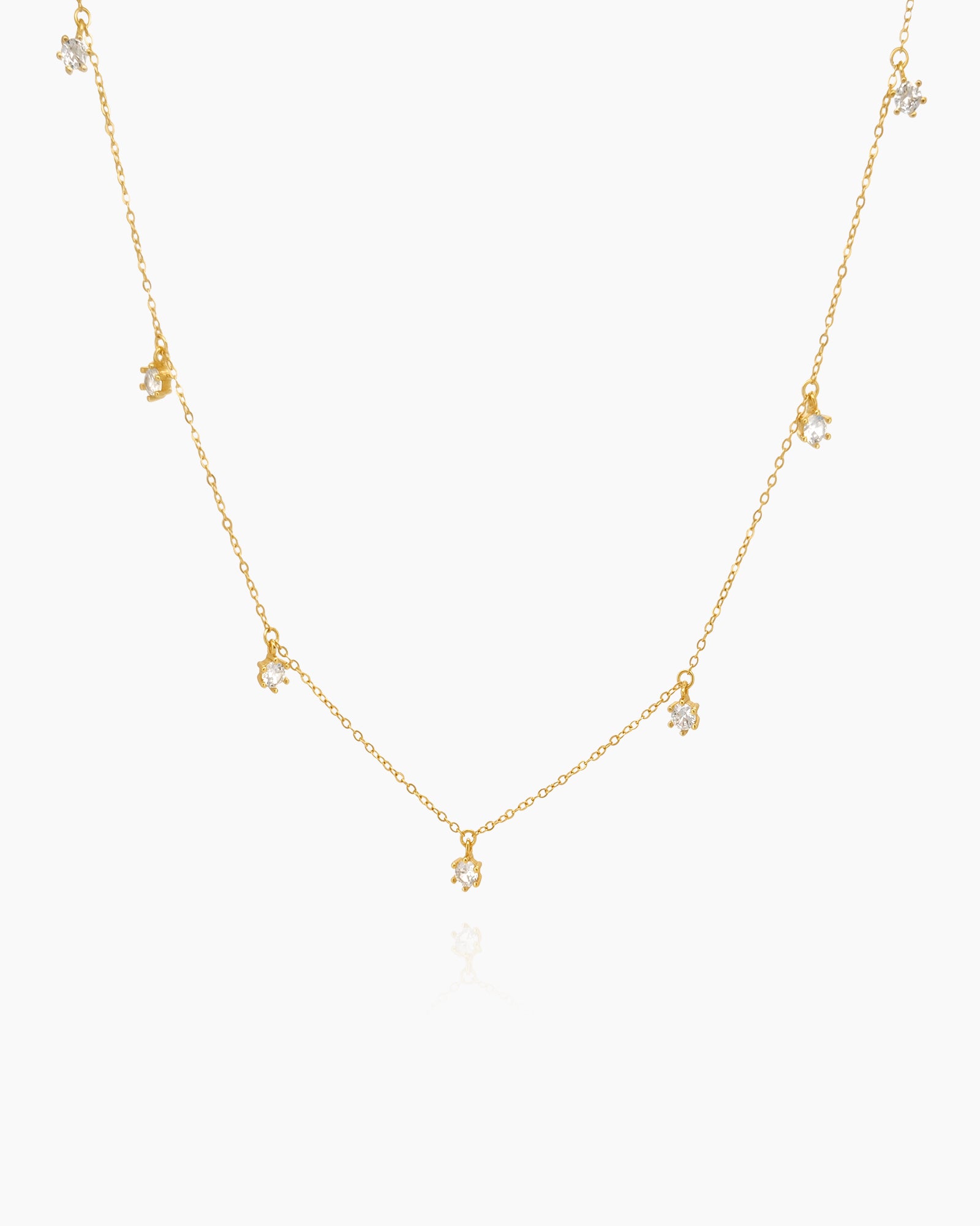 A choker on a fine gold-tone chain with tiny clustered zircons arranged like stars for a delicate look