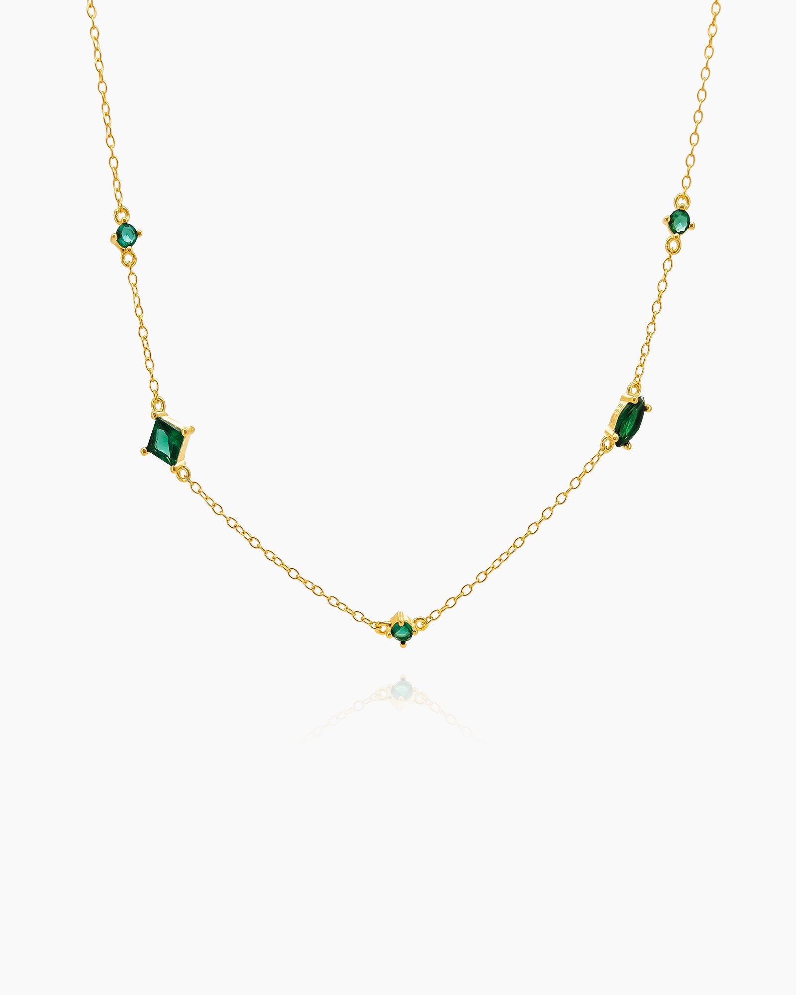 A necklace with a dance of green zircon stones in mixed cuts on a fine gold-plated chain