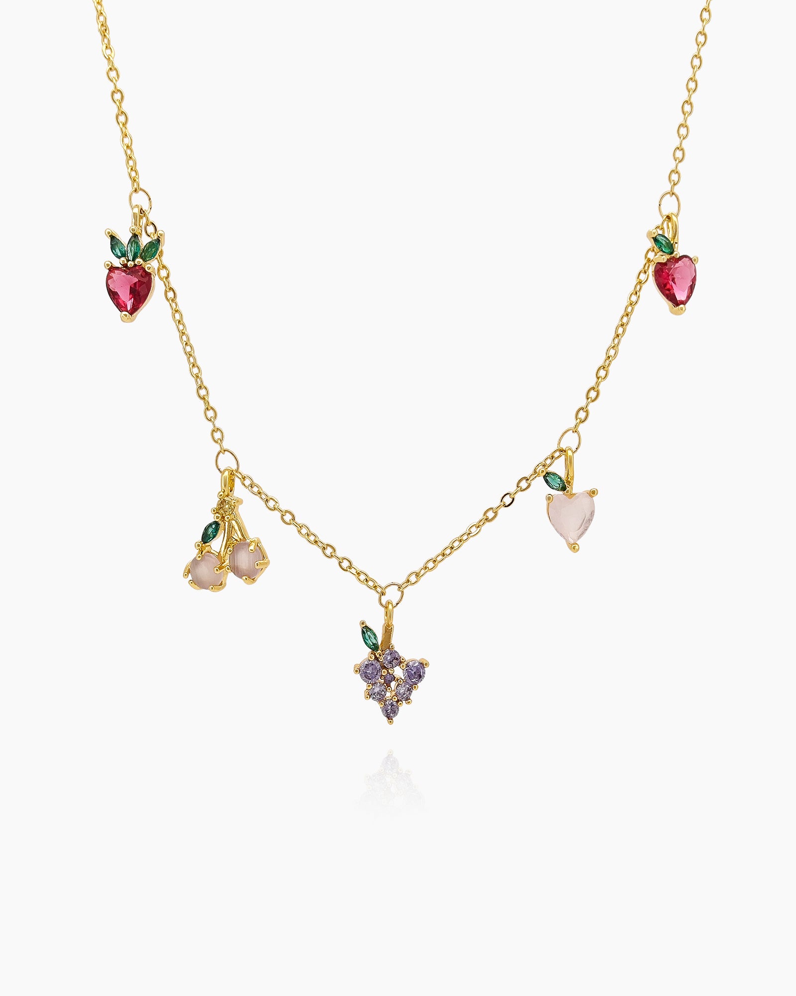 A necklace with tiny, sparkling zircon charms shaped like cherries, grapes, peaches, and berries