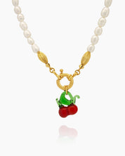 A necklace of timeless freshwater pearls with a glossy cherry pendant for a playful pop of color
