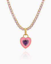 A light-pink tennis necklace with a full strand of zircon stones and an enamel heart charm with a center stone