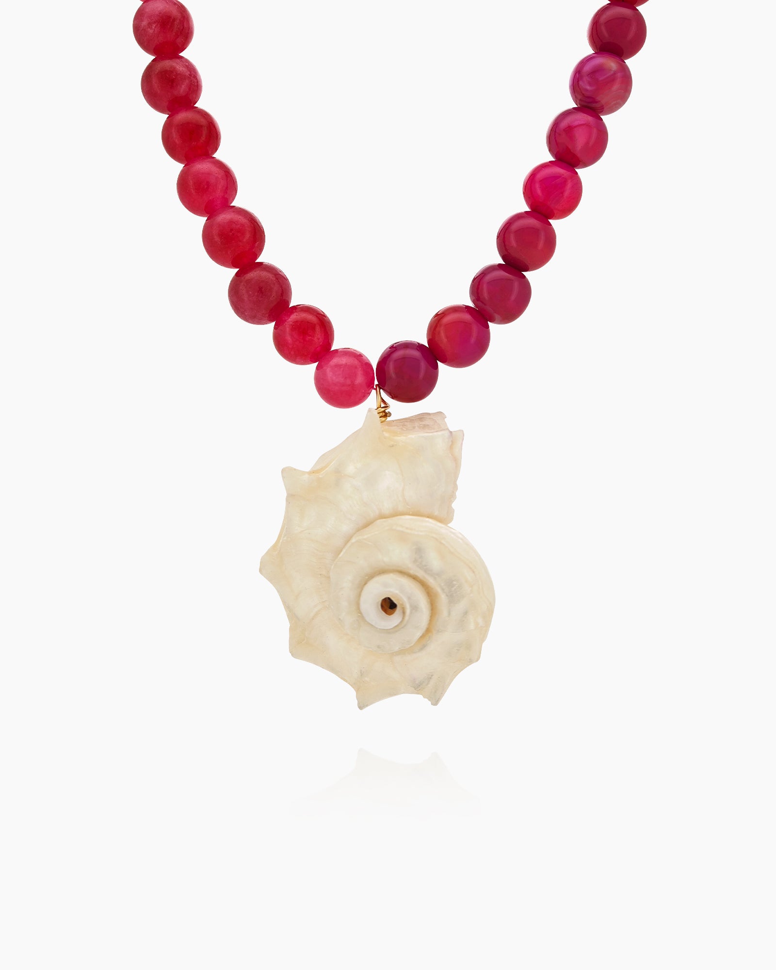 A necklace of raspberry-toned agate beads with a striking natural shell pendant at its heart