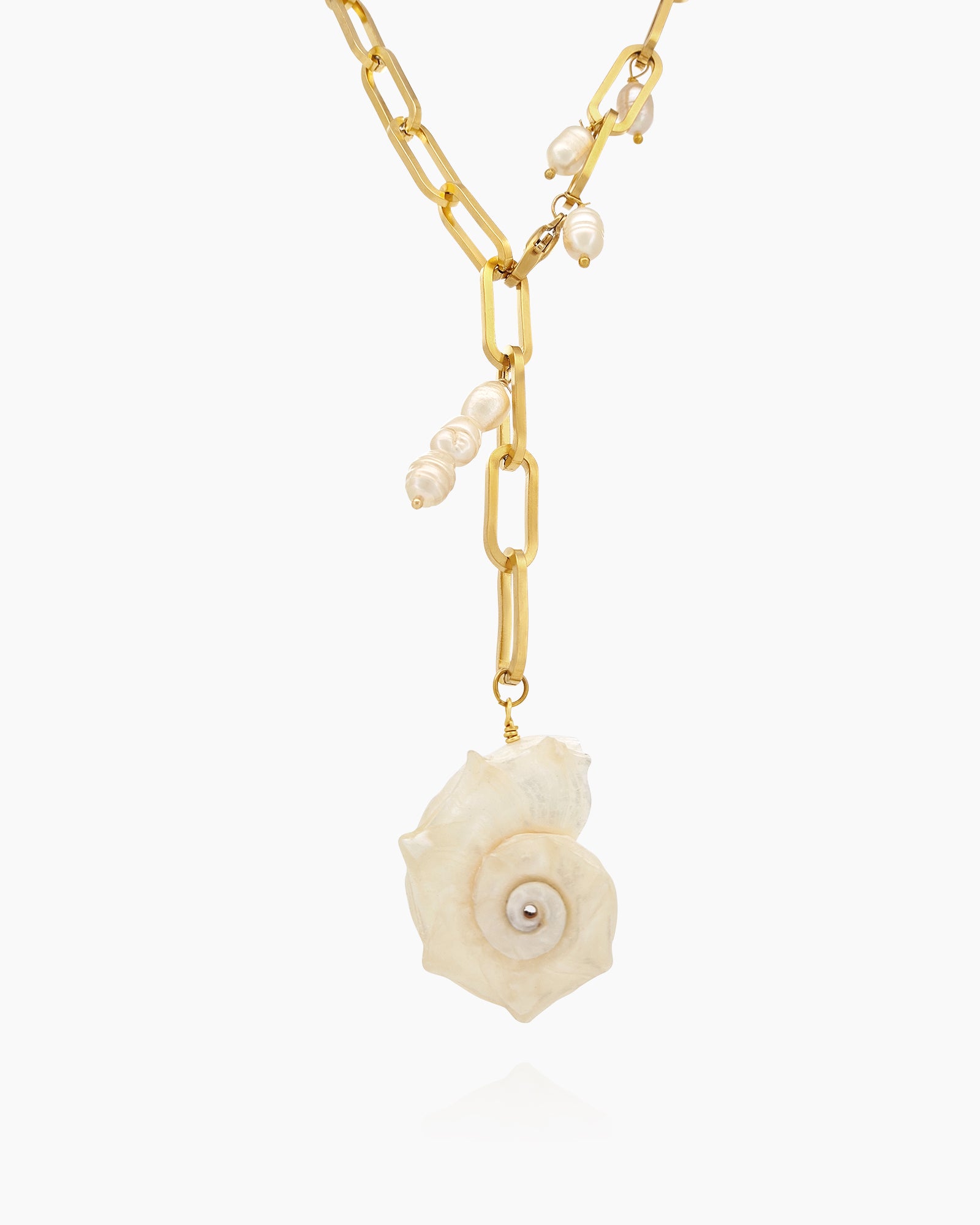 A chunky gold-tone paperclip chain necklace with delicate pearl droplets and a statement conch shell pendant