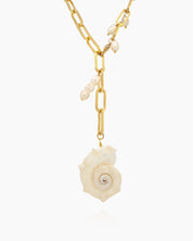 A chunky gold-tone paperclip chain necklace with delicate pearl droplets and a statement conch shell pendant