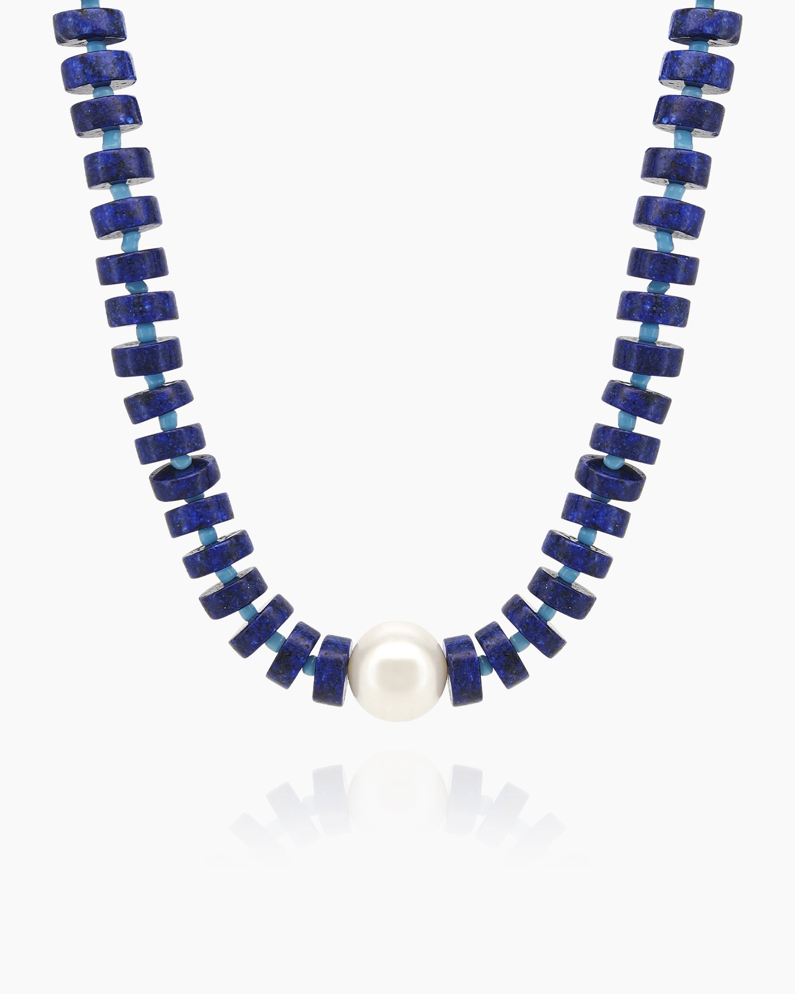 A sleek, structured necklace of navy-blue lapis lazuli beads with a glossy freshwater pearl at its heart