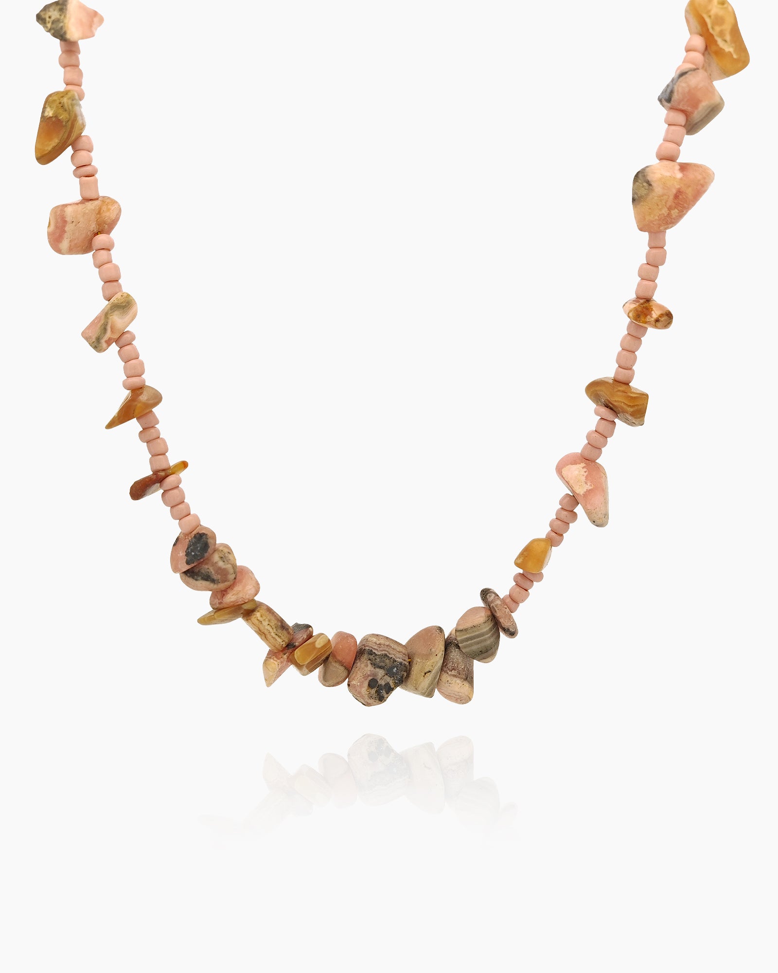 A beaded necklace with a mix of warm-hued agate chips and delicate pink seed beads for an earthy feel