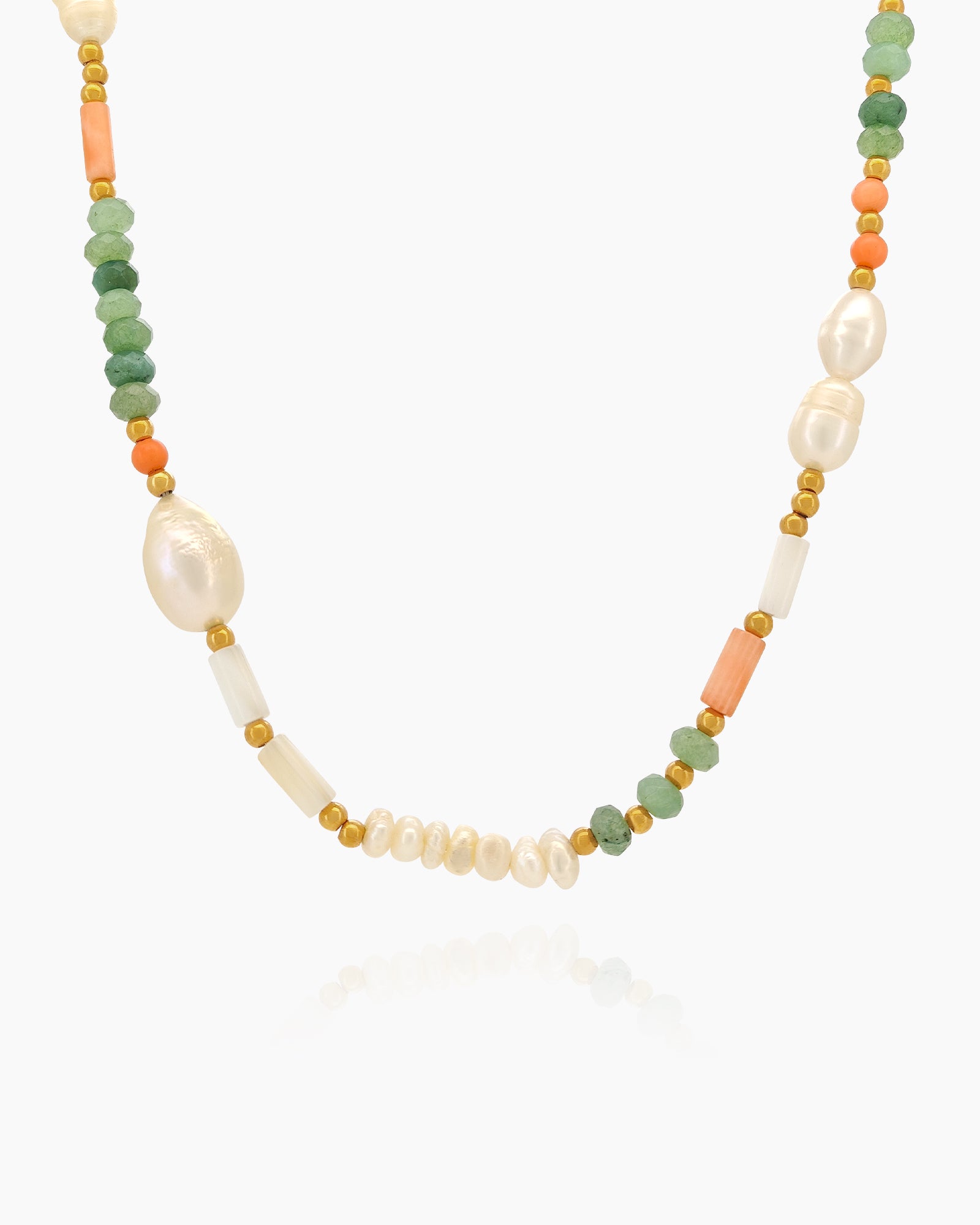 A beaded necklace with freshwater pearls, coral-hued cylinders, and sea-green faceted agate beads