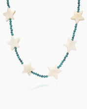 A necklace of mother-of-pearl stars strung along vibrant turquoise seed beads for a cosmic charm
