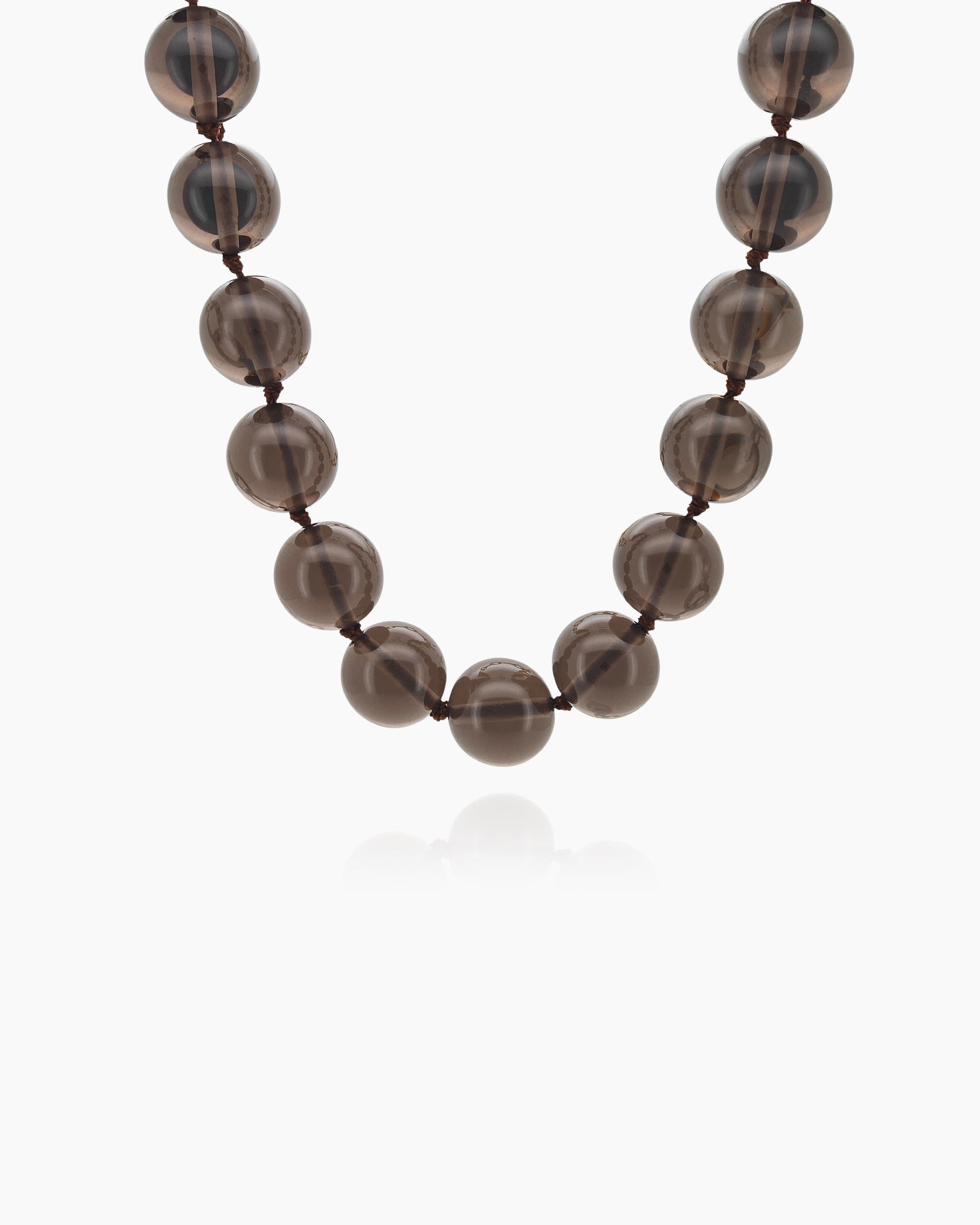 A '90s safari-style necklace with smooth, polished brown stones for a grounded, earthy charm