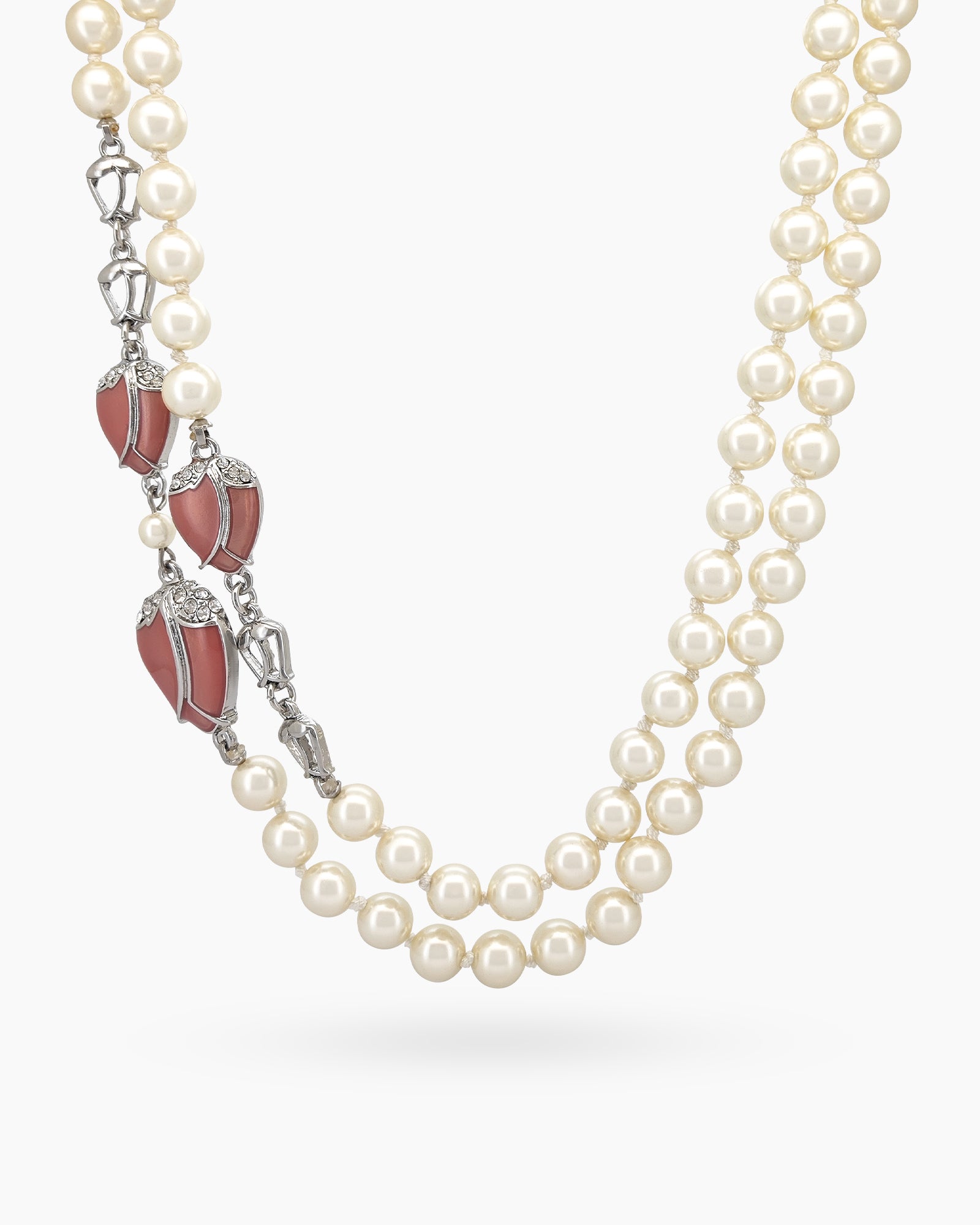A vintage opera necklace with double layers of luminous pearls, accented with vine-like silver twists