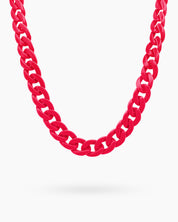 A glasses chain in pink with oversized, glossy color links for a playful and practical statement
