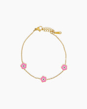 A pink bracelet with a delicate gold-tone chain adorned with a glossy enamel daisy