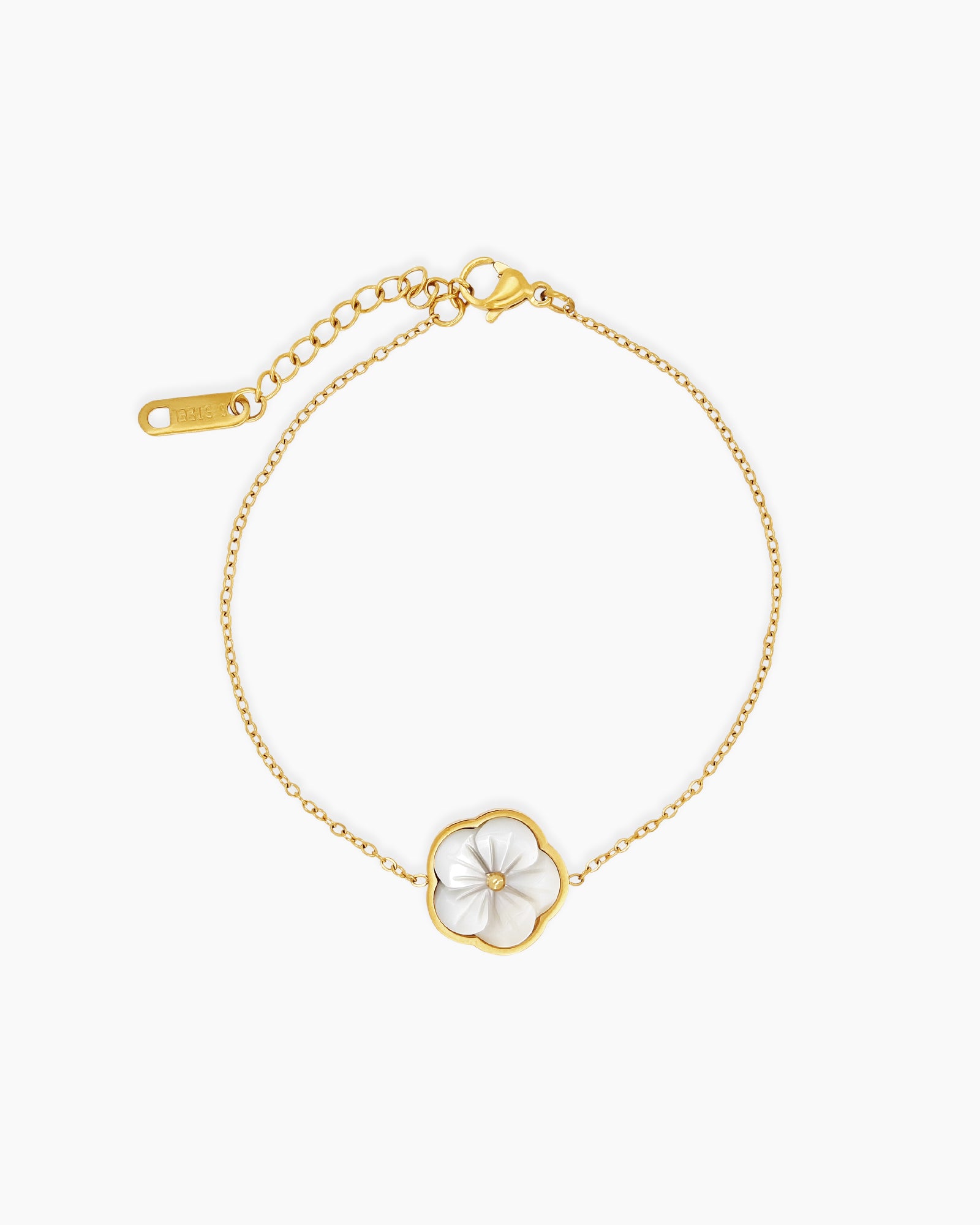 A bracelet with a sculpted white mother-of-pearl flower in a golden outline on a fine, adjustable chain