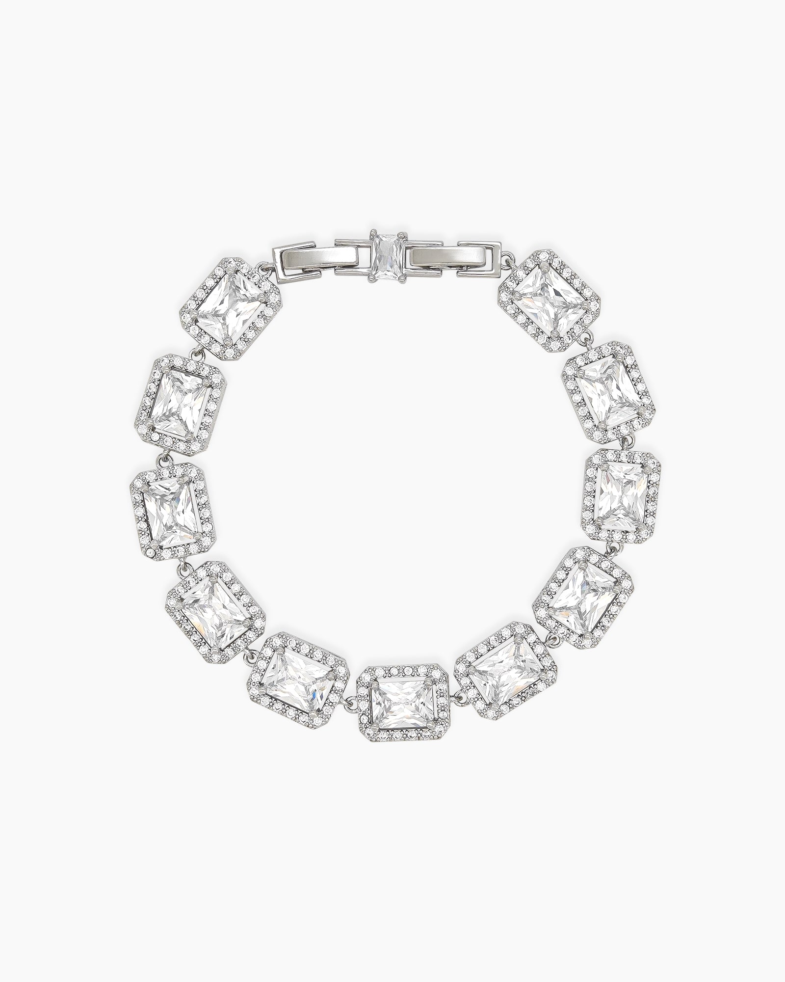 A white bracelet with emerald-cut stones framed by a halo of pavé-set zircons, exuding vintage glamour