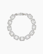 A white bracelet with emerald-cut stones framed by a halo of pavé-set zircons, exuding vintage glamour