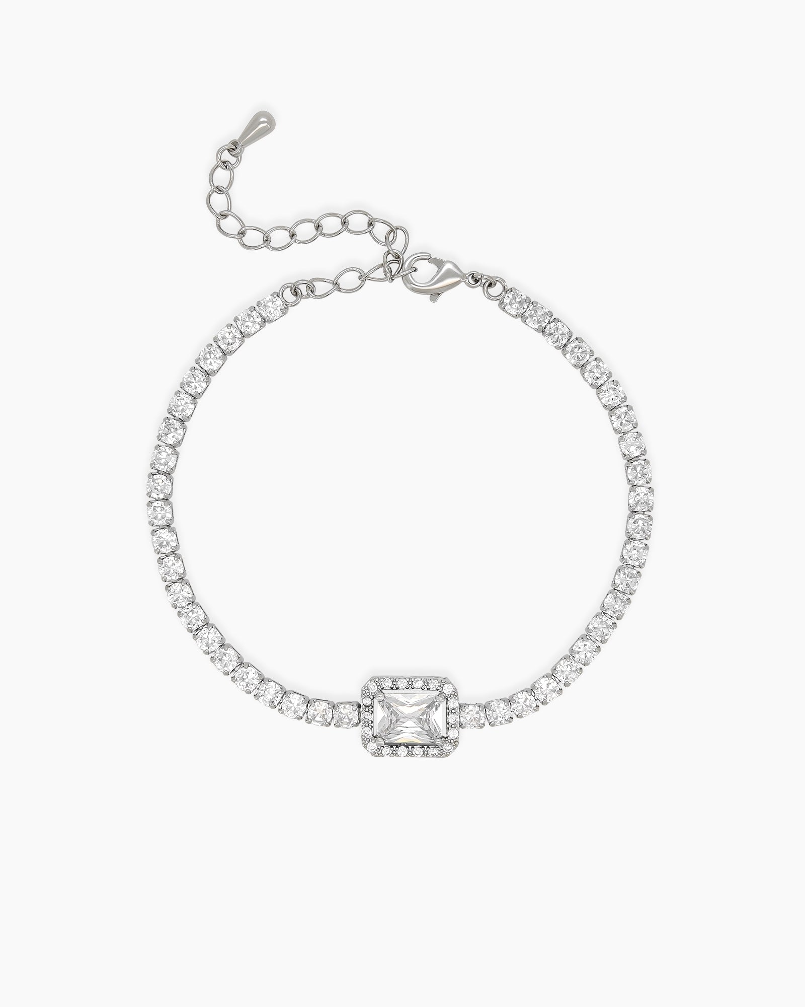 A white tennis-style bracelet with a dazzling emerald-cut zircon stone haloed in delicate pavé