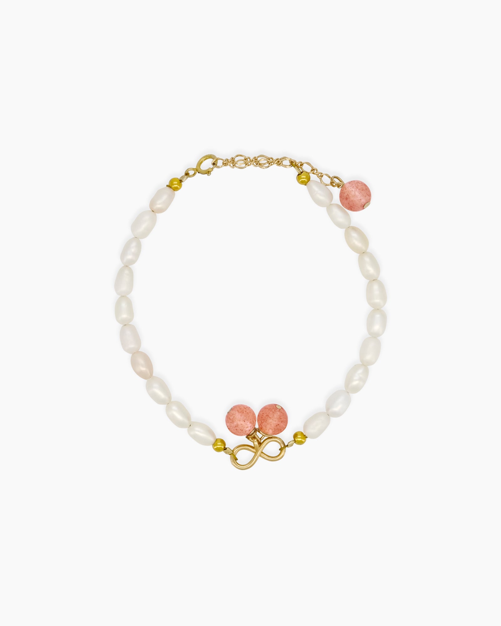 A bracelet of creamy freshwater pearls and delicate strawberry crystals, centered around a golden infinity charm